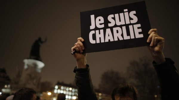 A man holds a placard which reads "I am Charlie" to pay tribute during a gathering at the Place de la Republique in Paris
