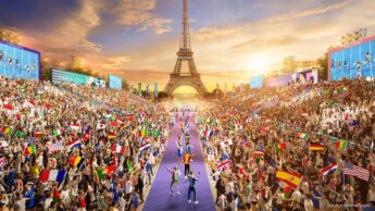 Imagem Jogos Olímpicos 2024, com multidão e atletas perante a Torre Eiffel