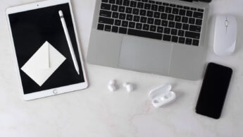 Dispositivos Apple espalhados numa mesa de trabalho