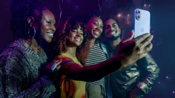 Grupo de pessoas a tirar uma selfie com um iPhone