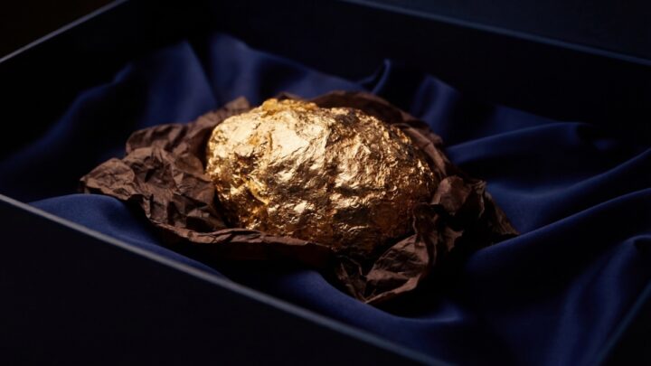 Imagem ovo de chocolate caviar com um iPhone 17 Pro Max em ouro no interior